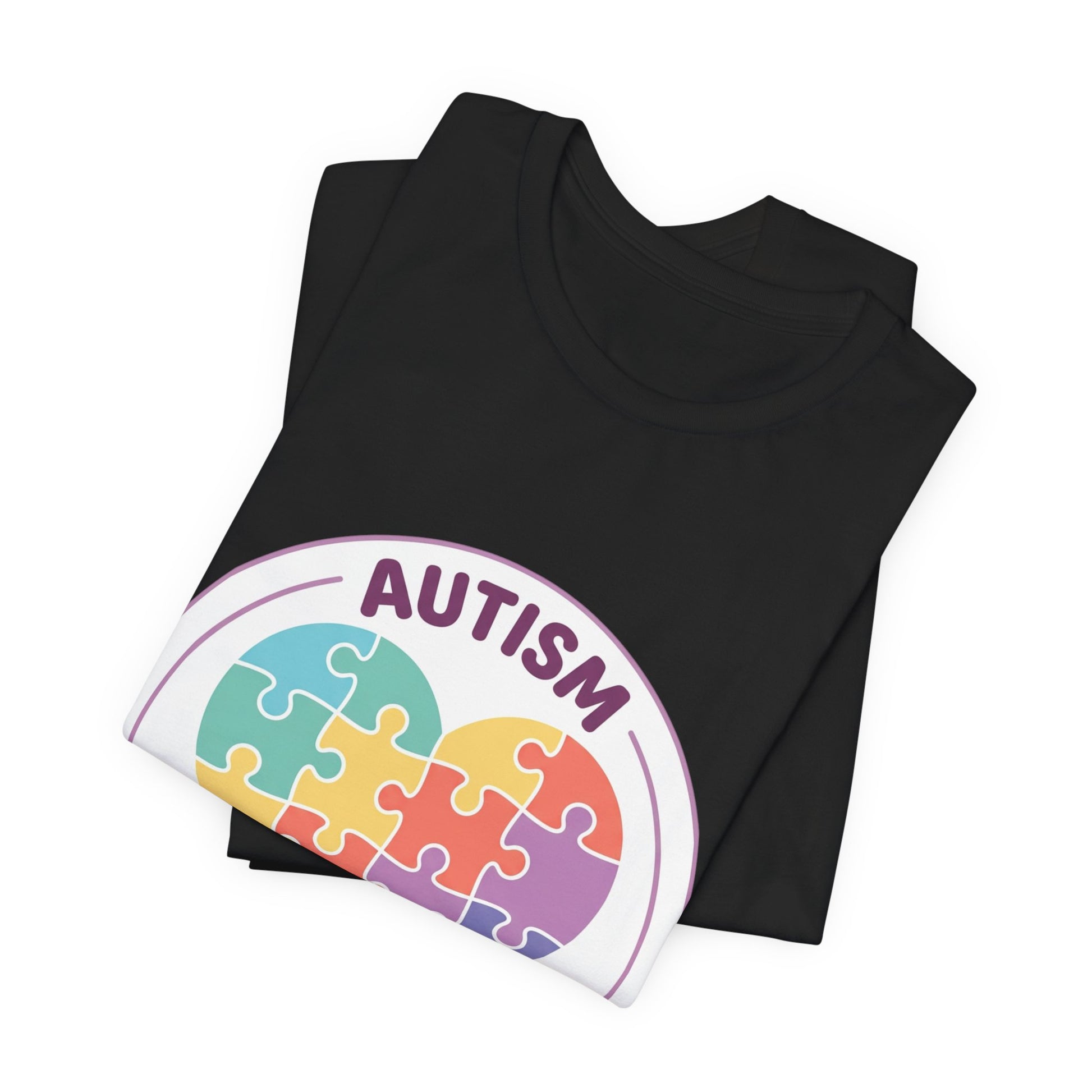 t-shirt with a colorful heart puzzle design and 'Autism Different Not Less' text on a white background