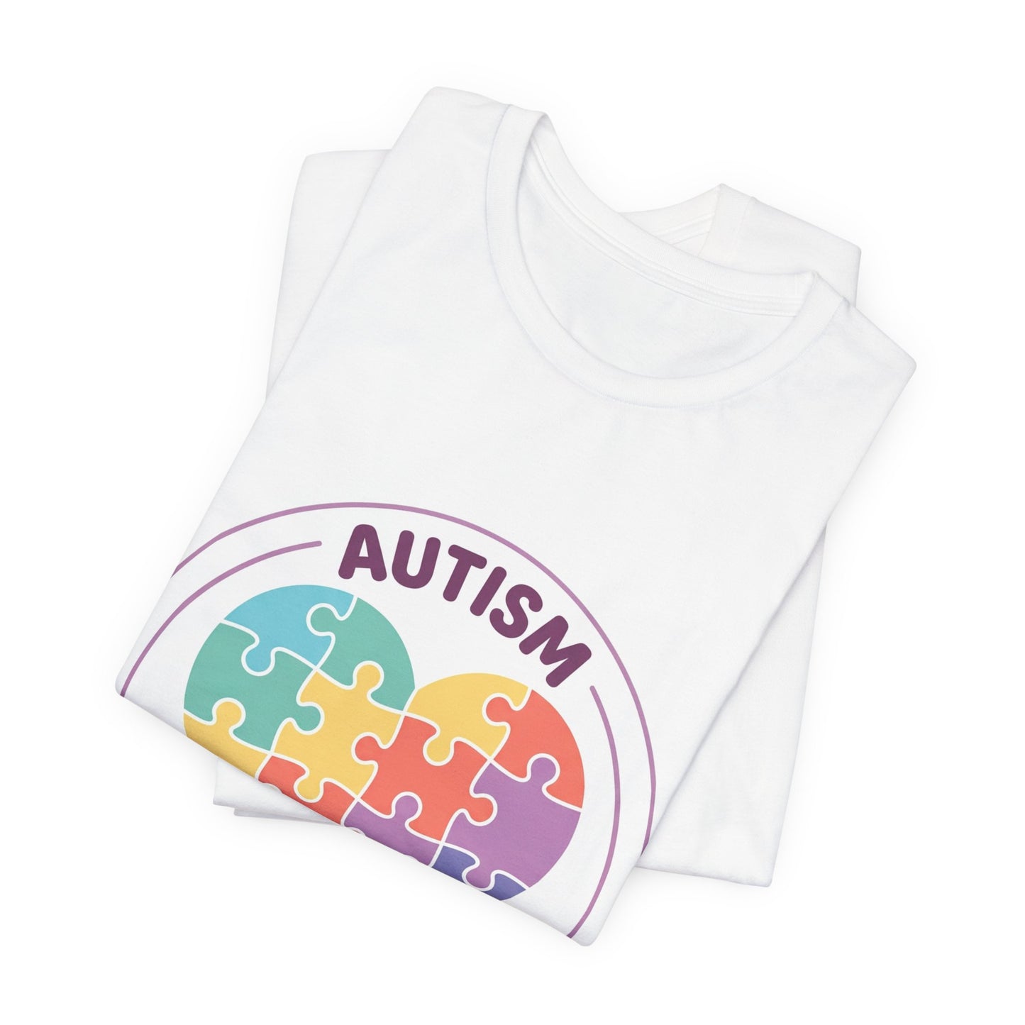 t-shirt with a colorful heart puzzle design and 'Autism Different Not Less' text on a white background