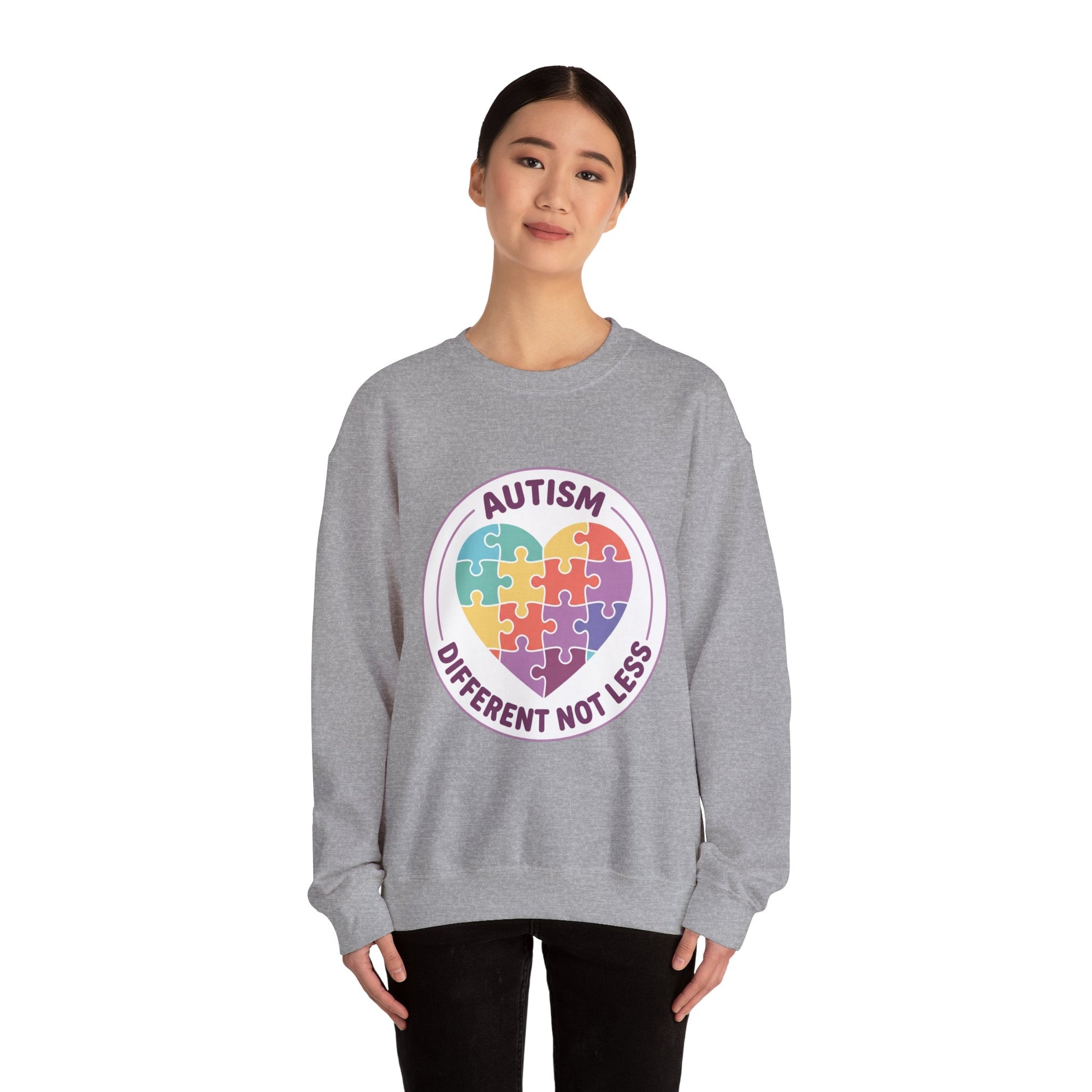 Sweatshirt with autism awareness design featuring a heart made of puzzle pieces on a white background