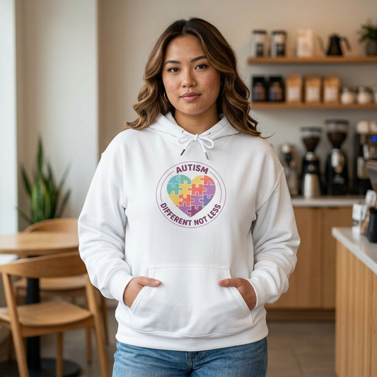 Person wearing a hoodie with an autism awareness design in a casual setting.