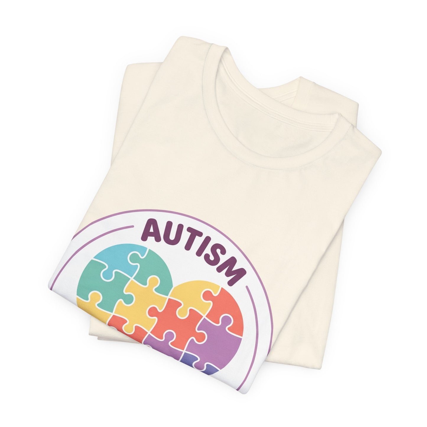 t-shirt with a colorful heart puzzle design and 'Autism Different Not Less' text on a white background