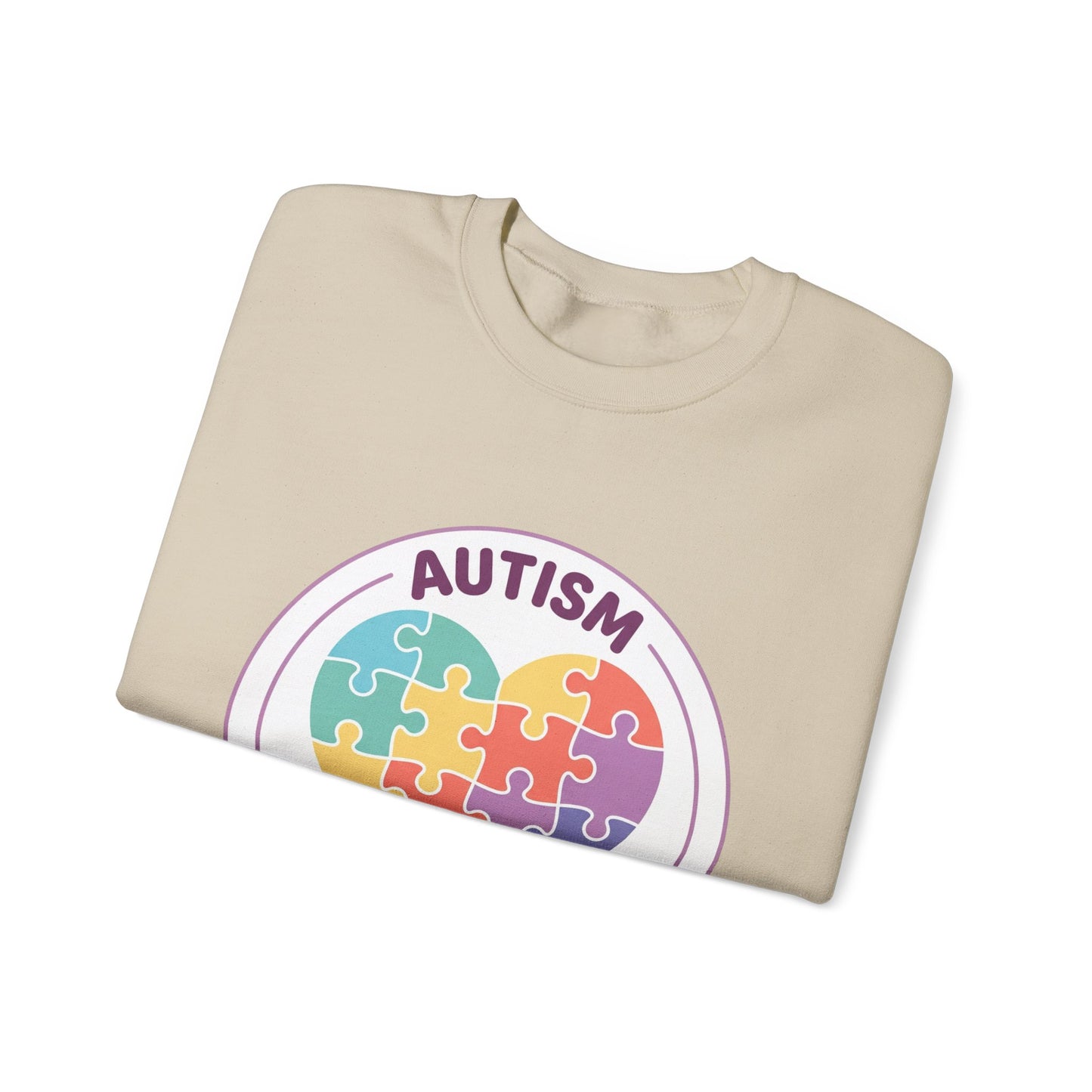Sweatshirt with autism awareness design featuring a heart made of puzzle pieces on a white background
