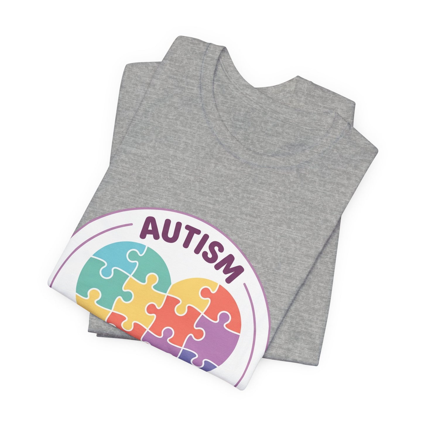 t-shirt with a colorful heart puzzle design and 'Autism Different Not Less' text on a white background