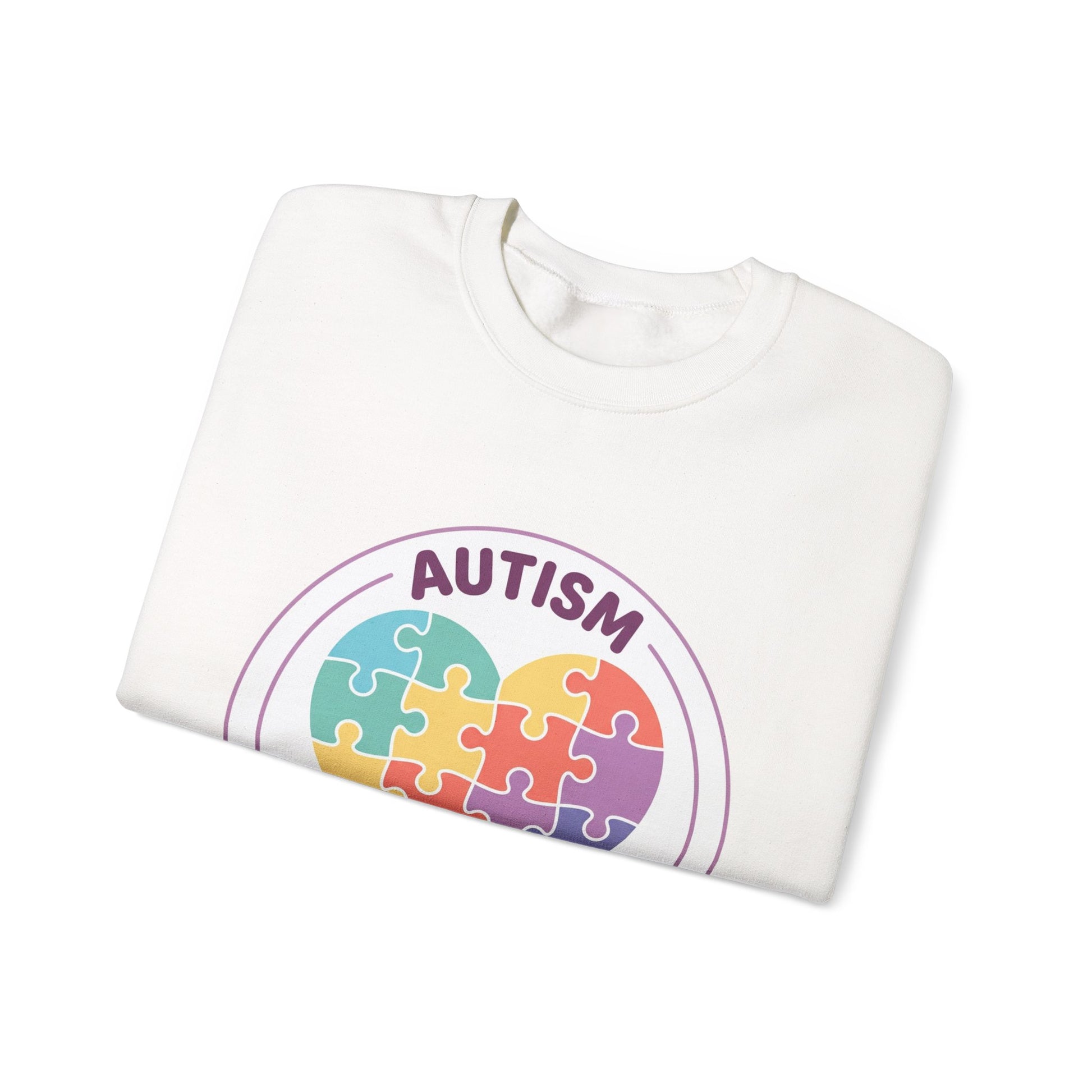 Sweatshirt with autism awareness design featuring a heart made of puzzle pieces on a white background