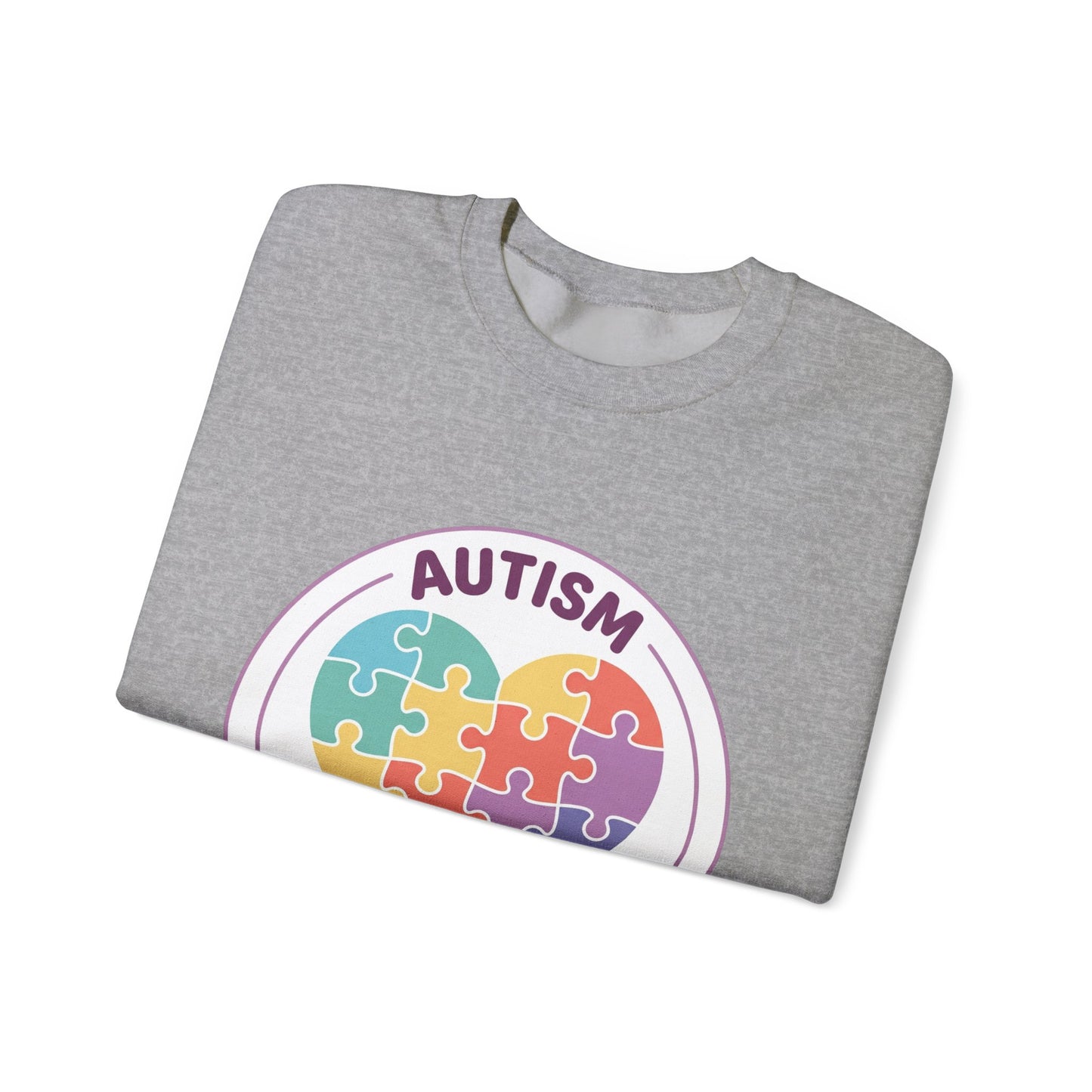Sweatshirt with autism awareness design featuring a heart made of puzzle pieces on a white background