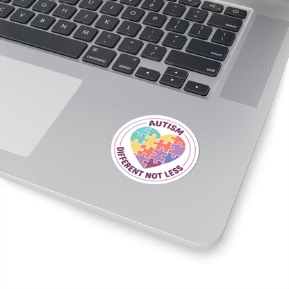 Laptop with a sticker featuring a heart-shaped puzzle piece and text 'Autism Different Not Less' on a white background.