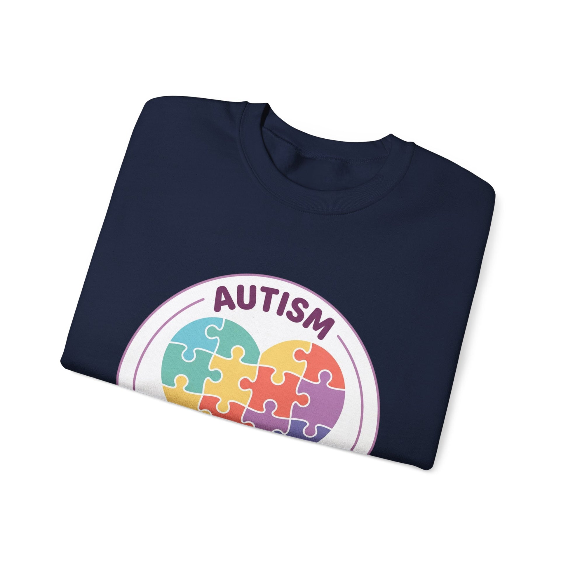 Sweatshirt with autism awareness design featuring a heart made of puzzle pieces on a white background