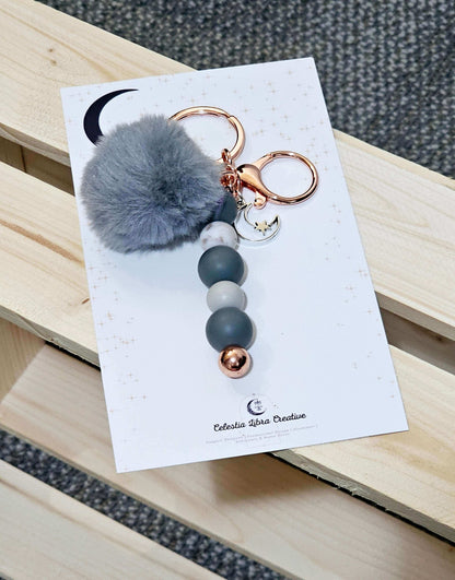 A grey and White Marble keychain handmade with a moon charm, handmade designs