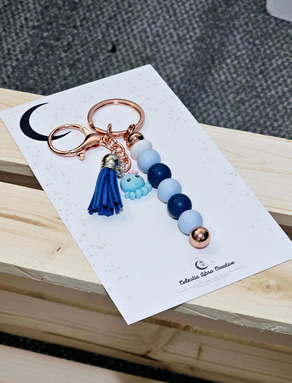 Navy and light blue keychain with navy tassel with a blue octopus. handmade designs